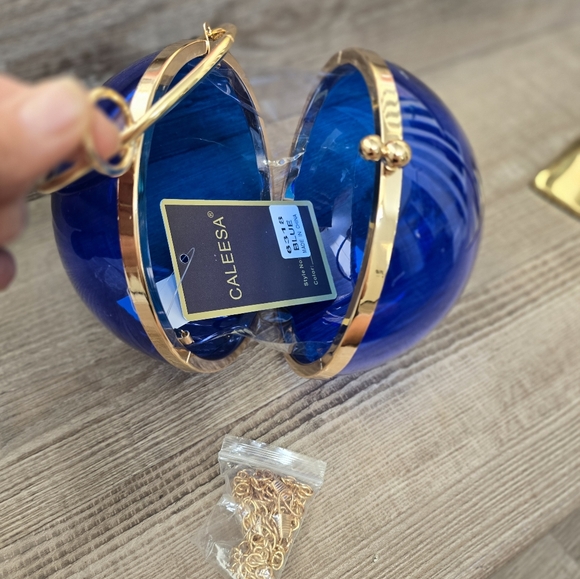 Cobalt blue wristlet round ball, gold trim and gold crossbody chain. - Picture 6 of 9